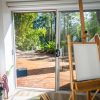 white canvas on easel with outdoor view